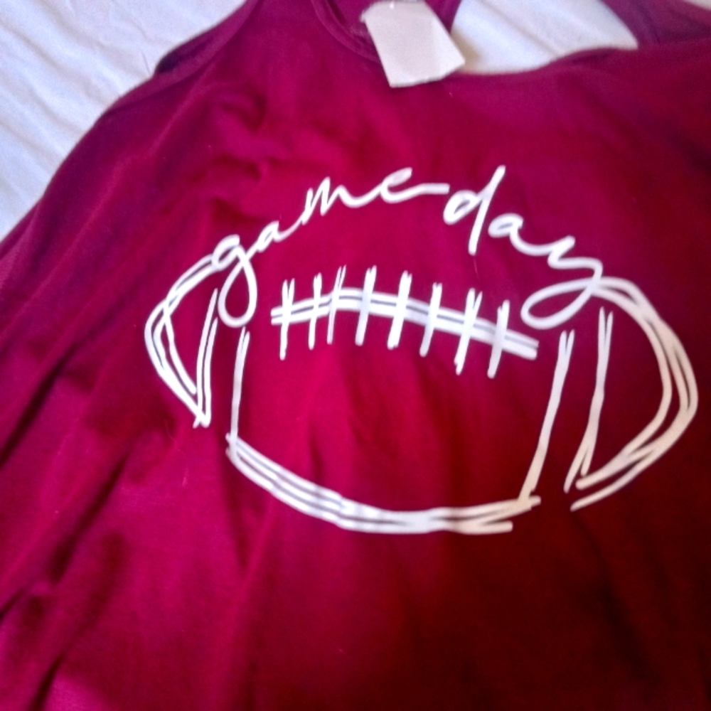 A red tank top with a football in front